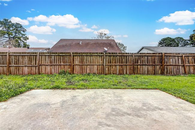 The backyard patio offers a perfect space for outdoor dining, barbecues, or simply relaxing in the fresh air. Surrounded by a privacy fence, this blank canvas awaits your personal touch to transform it into your dream outdoor oasis. | Image 22
