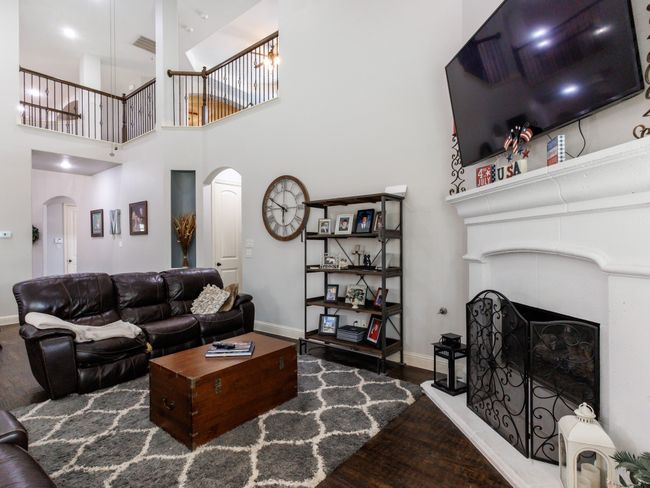 The living is spacious and is complete with a welcoming fireplace, perfect for gathering around during the cooler months. | Image 9