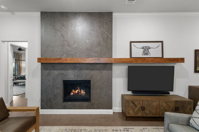 Living room is anchored by a stunning modern fireplace | Image 9