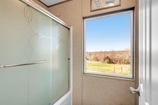 Bathroom with an enclosed shower | Image 34