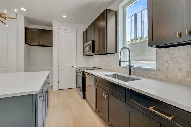 Kitchen with a sink, stainless steel appliances, light wood-style floors, backsplash, and recessed lighting | Image 5