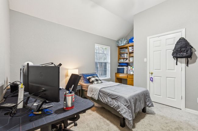 Carpeted bedroom featuring lofted ceiling | Image 22