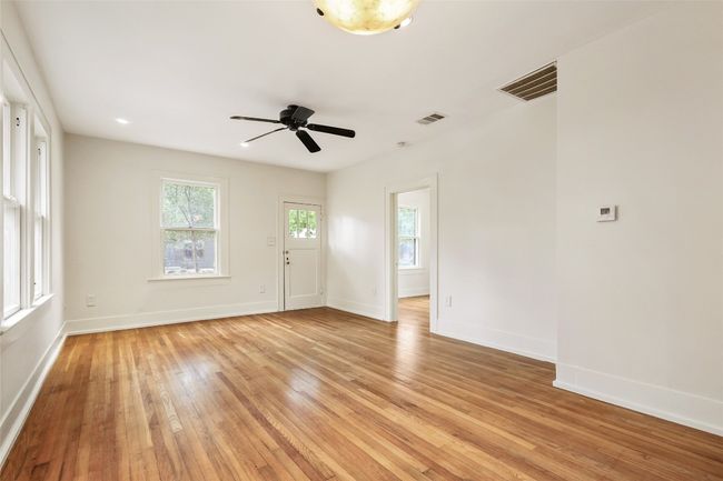 Unfurnished room with light wood-style flooring and a ceiling fan | Image 11