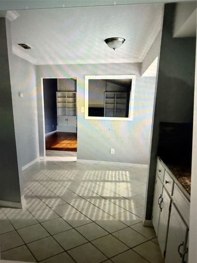 Unfurnished dining area featuring tile patterned flooring and wallpapered walls | Image 10