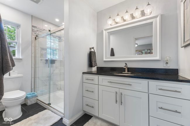 full bath with vanity, a shower stall, and tile patterned flooring | Image 23