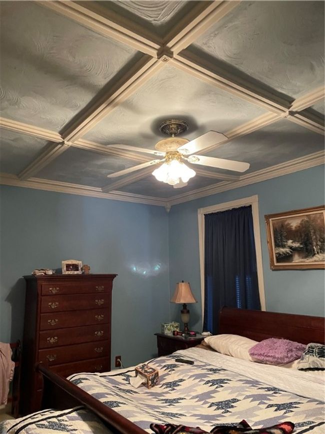 Coffered ceiling and ceiling fan in primary bedroom | Image 12