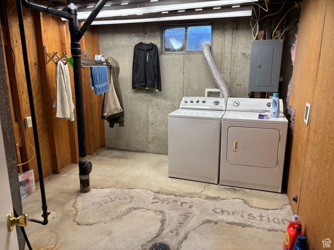 Laundry room featuring electric panel and washing machine and clothes dryer | Image 19