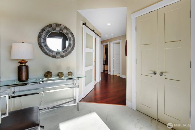 Custom tile flooring in the foyer along with handy closet is the perfect drop zone for shoes and coats. | Image 5