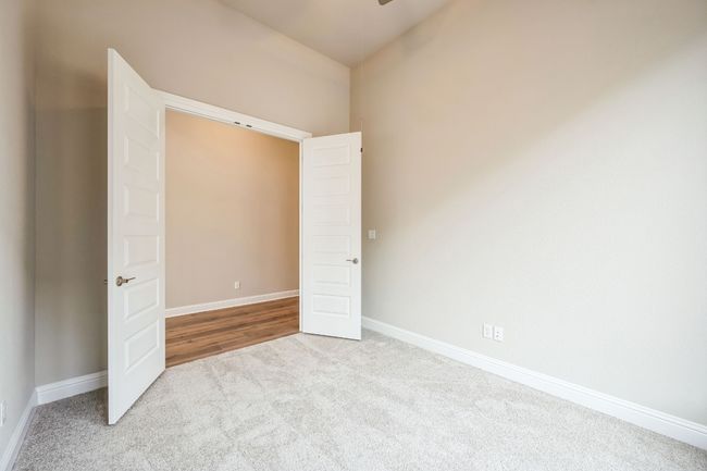 Unfurnished bedroom featuring baseboards and light colored carpet | Image 23