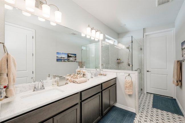 Bathroom featuring a sink, double vanity, visible vents, and a shower stall | Image 17