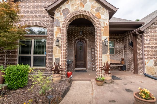 Doorway to property featuring brick siding | Image 4