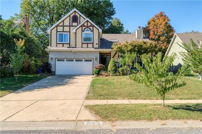 Tudor house with a garage and a front lawn | Image 1