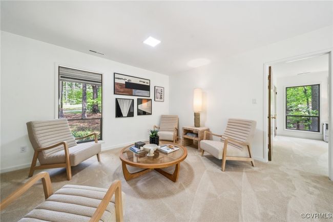 Living room with light colored carpet, baseboards, and a healthy amount of sunlight | Image 35