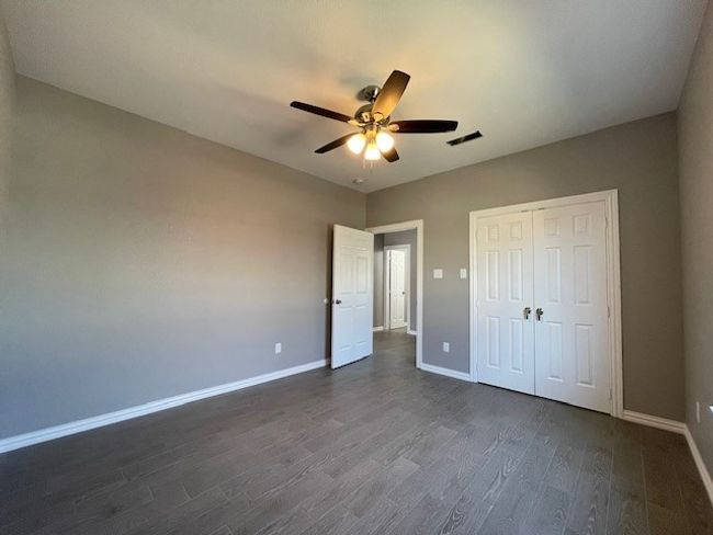3rd bedroom featuring wood-style flooring, a closet, ceiling fan, and baseboards | Image 21
