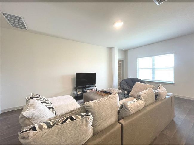 Living room featuring baseboards and dark wood-style flooring | Image 8