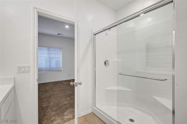 Full bathroom with visible vents, a stall shower, baseboards, tile patterned floors, and vanity | Image 36