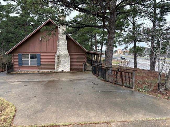View of side of property featuring log siding, fence, and a chimney | Image 22