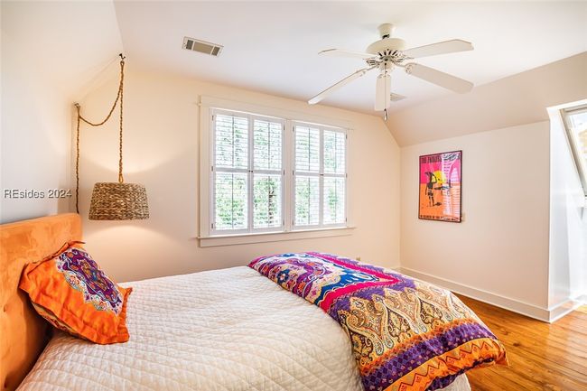 Bedroom featuring hardwood / wood-style flooring, ceiling fan, and vaulted ceiling | Image 39