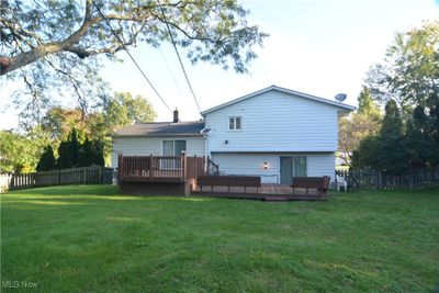 Back of house featuring a deck and a yard | Image 2