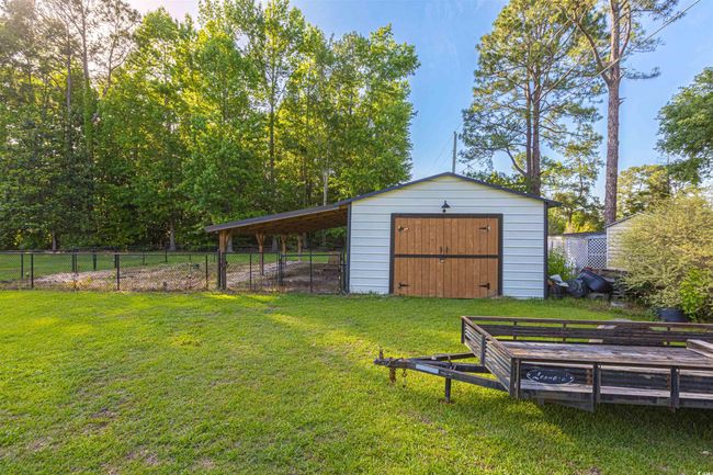 View of yard featuring a garage and an outdoor structure | Image 32