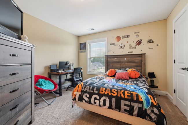 Bedroom 2 features a single window and carpeted flooring. 1107 Sycamore Leaf Way Murfreesboro, TN 37129 | Image 24