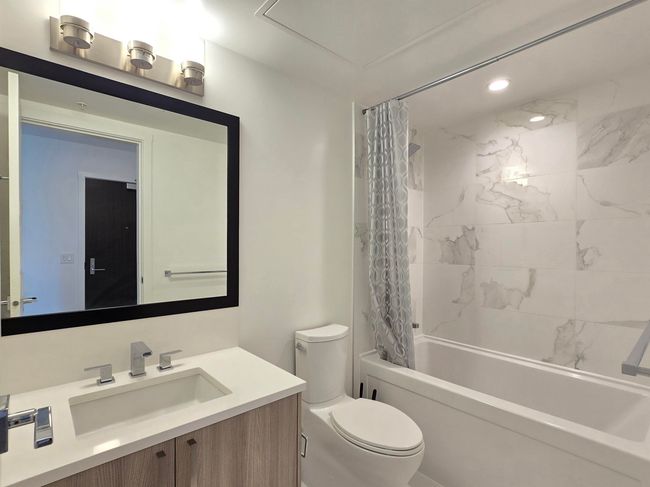 Bathroom with vanity, shower / bath combination with curtain, and recessed lighting | Image 14