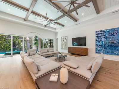 Living room with ceiling fan, beam ceiling, and light hardwood / wood-style flooring | Image 3