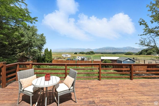 Wooden deck with a mountain view, a fenced backyard, and a view of rural / pastoral area | Image 26