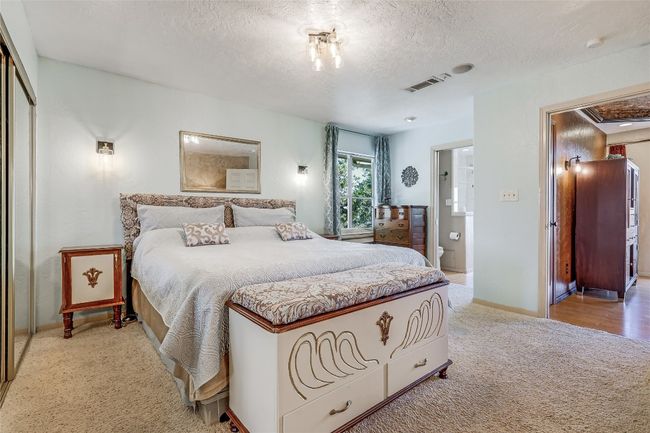 Off of the Sitting Area, let's check out the Primary Suite. Generous Sized Bedroom, easily accommodates a King-Sized Bed, and includes 2 Standard Closets. | Image 26