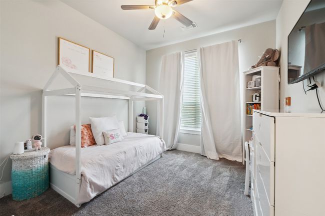 Carpeted bedroom with ceiling fan and baseboards | Image 4