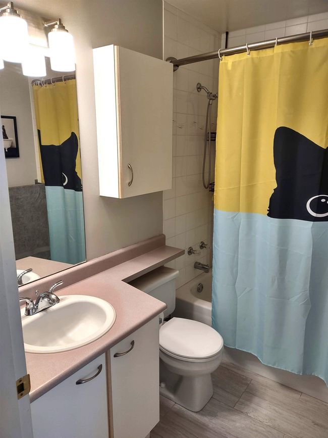 Full bathroom with toilet, shower / bath combo, wood finished floors, and vanity | Image 19