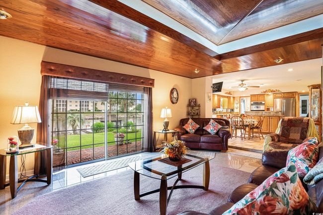 Living area with light tile patterned floors, recessed lighting, and a ceiling fan | Image 13