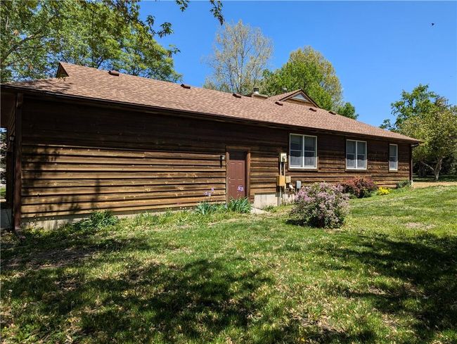 Back of house featuring a shingled roof and a lawn | Image 6