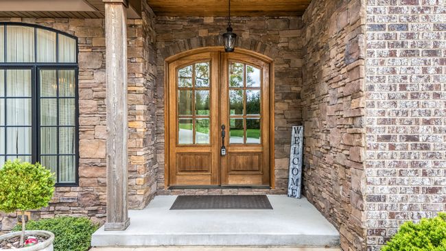 The double wood door entrance to this gorgeous home sets the stage for a warm and inviting welcome to both family and visitors. | Image 6