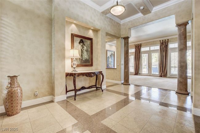 Foyer entrance with baseboards, ornate columns, ornamental molding, and beamed ceiling | Image 5