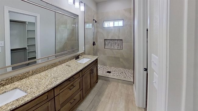 Full bathroom with a sink, double vanity, wood finished floors, and walk in shower | Image 18