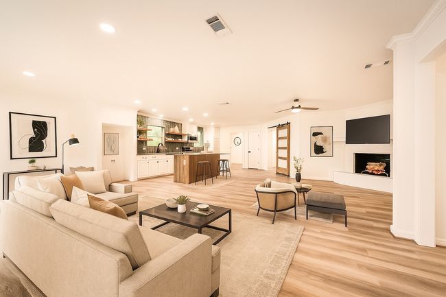 Living room featuring a barn door, recessed lighting, light wood-style flooring, and ceiling fan | Image 7