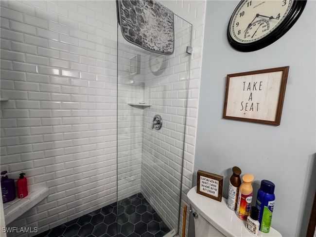 Bathroom featuring a shower stall and tile patterned flooring | Image 15