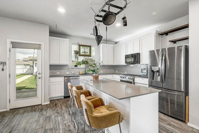 Easy access to the backyard and back patio from the kitchen and dining area. | Image 9