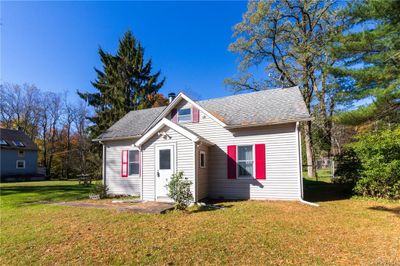 View of front facade with a front lawn | Image 1