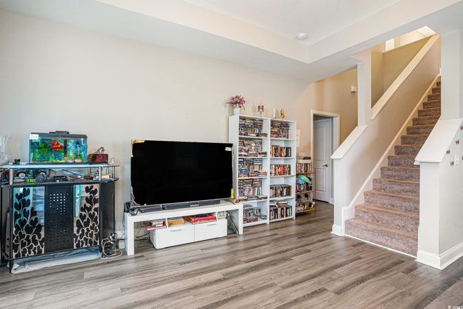 Living area featuring wood finished floors and stairs | Image 5