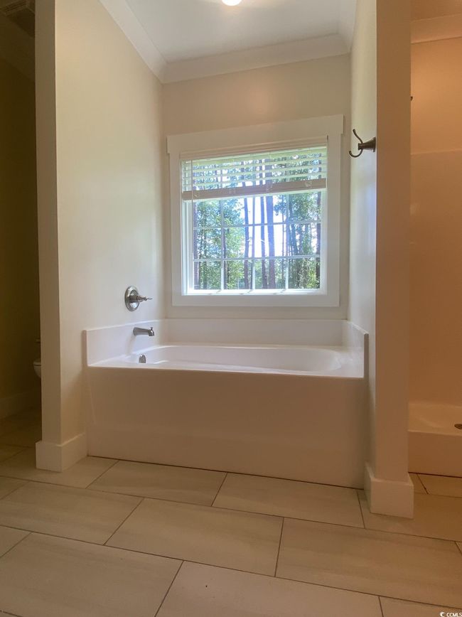 Bathroom featuring vanity, a bath, and tile patterned flooring | Image 27