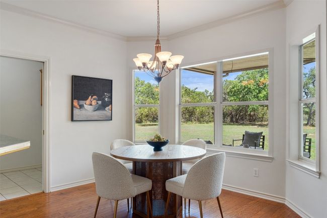 The breakfast area is nestled in a bay window with tranquil backyard views — the ideal spot for morning coffee. | Image 8