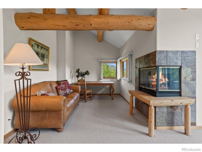 Primary suite sitting area and fireplace | Image 32