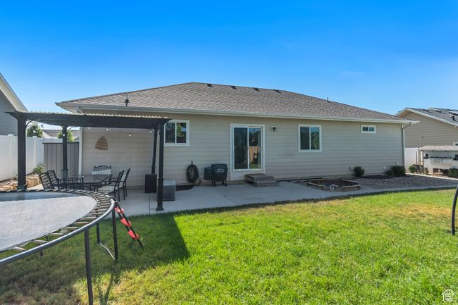 Rear view of property with a patio area, a shingled roof, and entry steps | Image 30