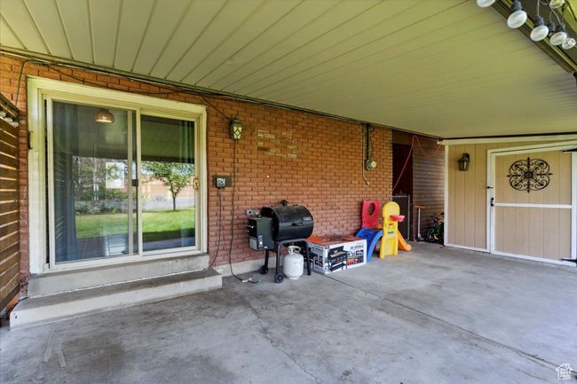 View of patio featuring area for grilling | Image 26