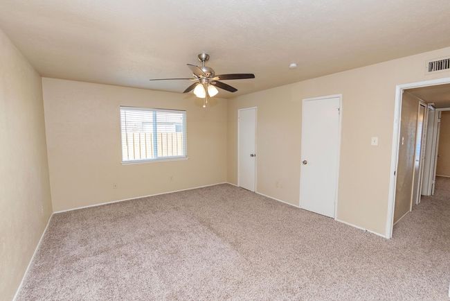 Carpeted spare room with ceiling fan | Image 16