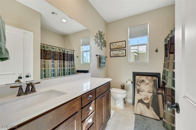 Full bathroom with visible vents, baseboards, toilet, vanity, and tile patterned flooring | Image 33