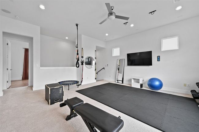 Loft space featuring an exercise area with a ceiling fan, recessed lighting, and carpet | Image 19