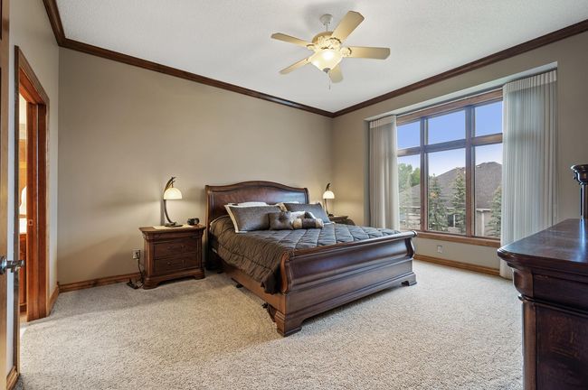 Your private personal main level ensuite with natural sunlight filling the space each day. 10' high ceilings, crown molding & neutral window treatments continue the luxury finishes throughout. | Image 16